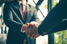 Free Two Confident Businessman Shaking Hands For Demonstrating Their Stock Photography - 114956402