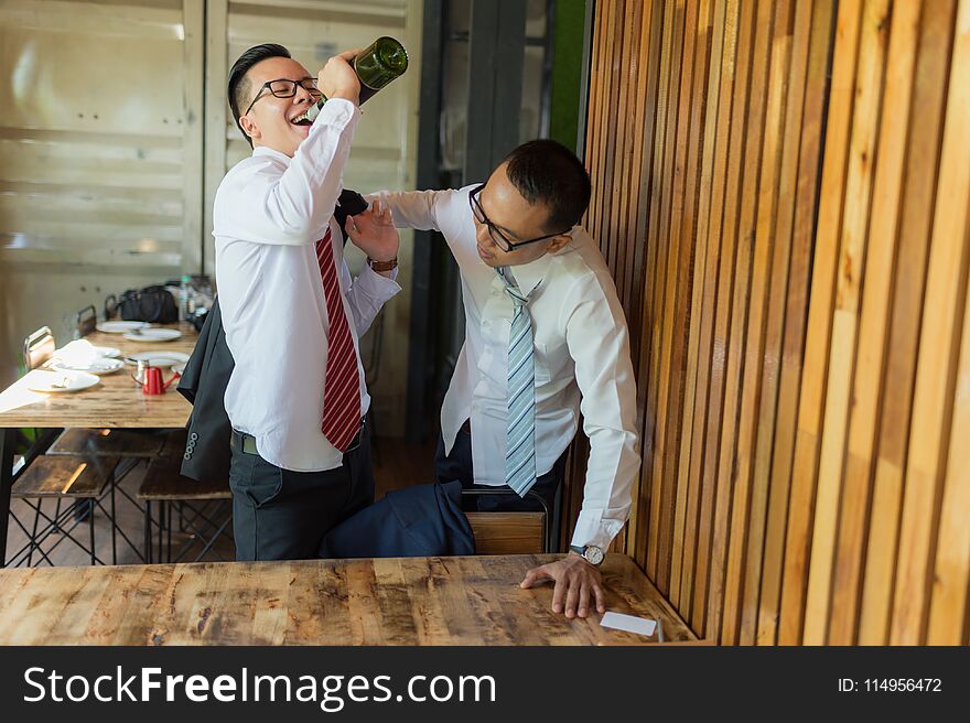 Two businessman is drunk and laughing after drinking hard in restaurant to celebrate the success of work