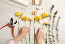 Female Florist Making Beautiful Bouquet At Table Stock Image