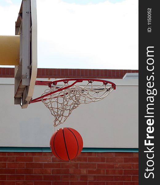 A basketball swishing through the net. A basketball swishing through the net.