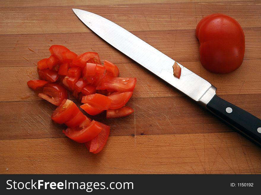 A fresh tomato being cut. A fresh tomato being cut.