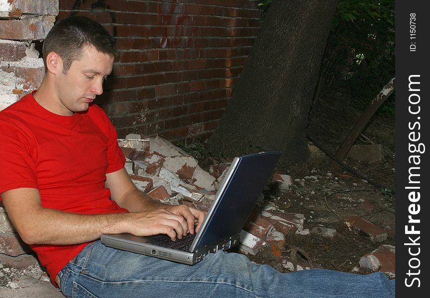 Twenty-six year old man working on laptop. Twenty-six year old man working on laptop.