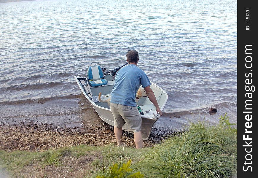 A young man eager to catch some fish in Timothy Laek launches his boat out into the deep (for those who are curious, this young man caught no fish during this particular camping adventure...he was quite disappointed). A young man eager to catch some fish in Timothy Laek launches his boat out into the deep (for those who are curious, this young man caught no fish during this particular camping adventure...he was quite disappointed)