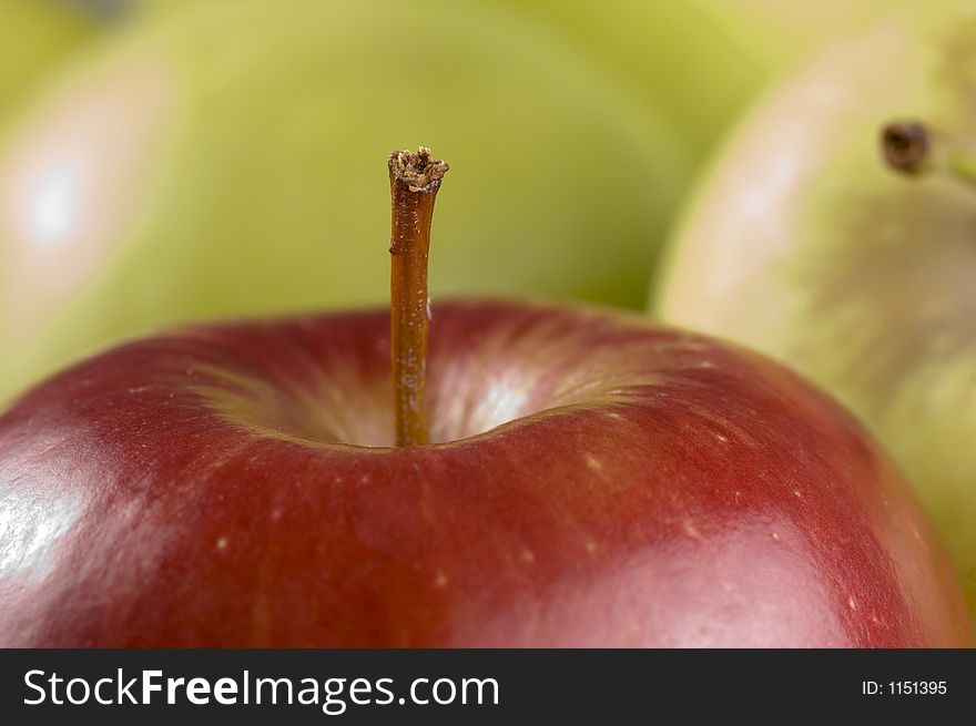 Red apple close up with background of green apples. Red apple close up with background of green apples