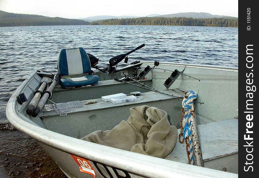 A fishing boat rests peacefully on the banks of Timothy Lake