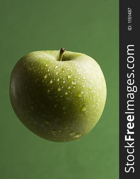 Isolated green apple appears to be floating on green background