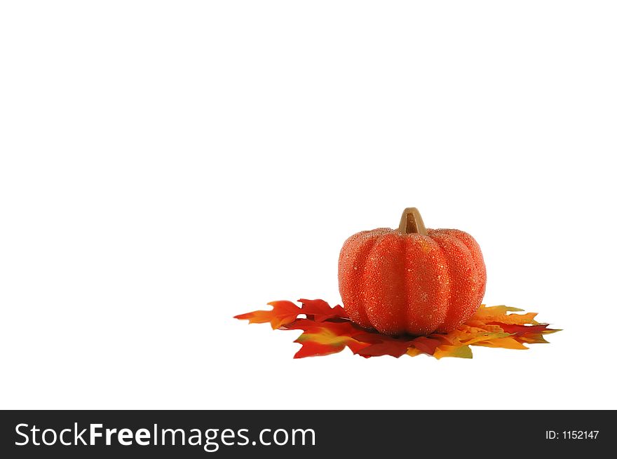 Miniature bright beaded pumpkin with colorful leafs in a right conner - isolated on white. Miniature bright beaded pumpkin with colorful leafs in a right conner - isolated on white