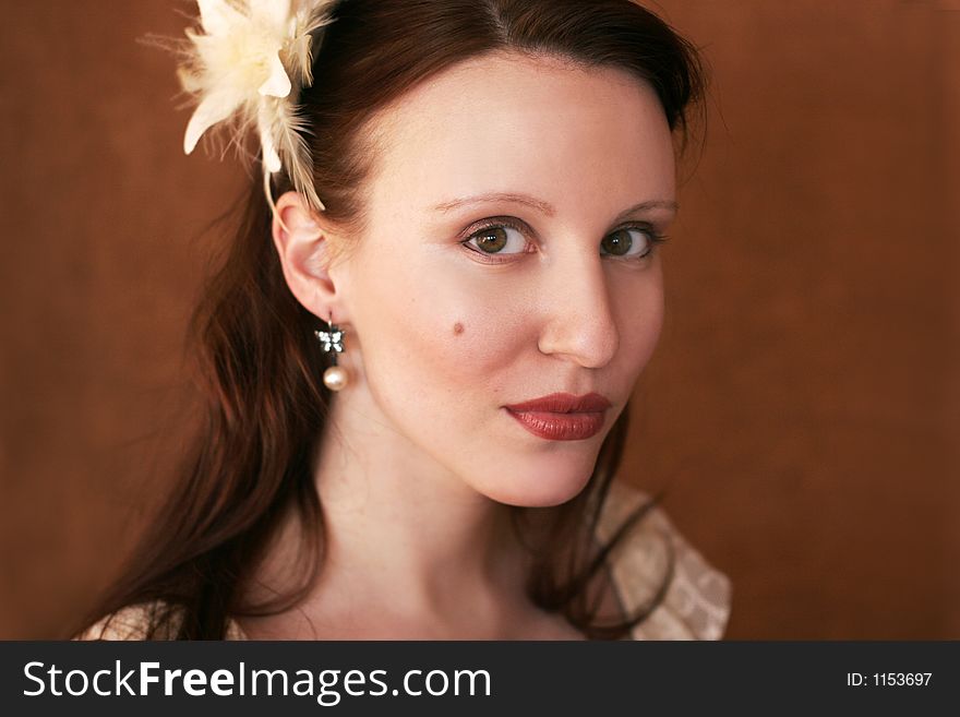 Portrait of a beautiful young woman with feathers in her hair. Portrait of a beautiful young woman with feathers in her hair.