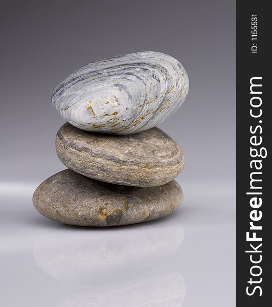 Three pebbles balancing on each other