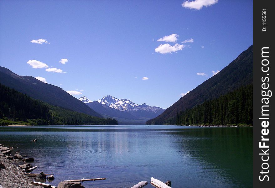 Lake located in the Rocky Mountains, snow capped mountain in background. Lake located in the Rocky Mountains, snow capped mountain in background.