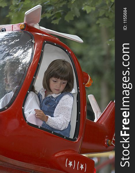 Young girl in the red helicopter on the playground. Young girl in the red helicopter on the playground