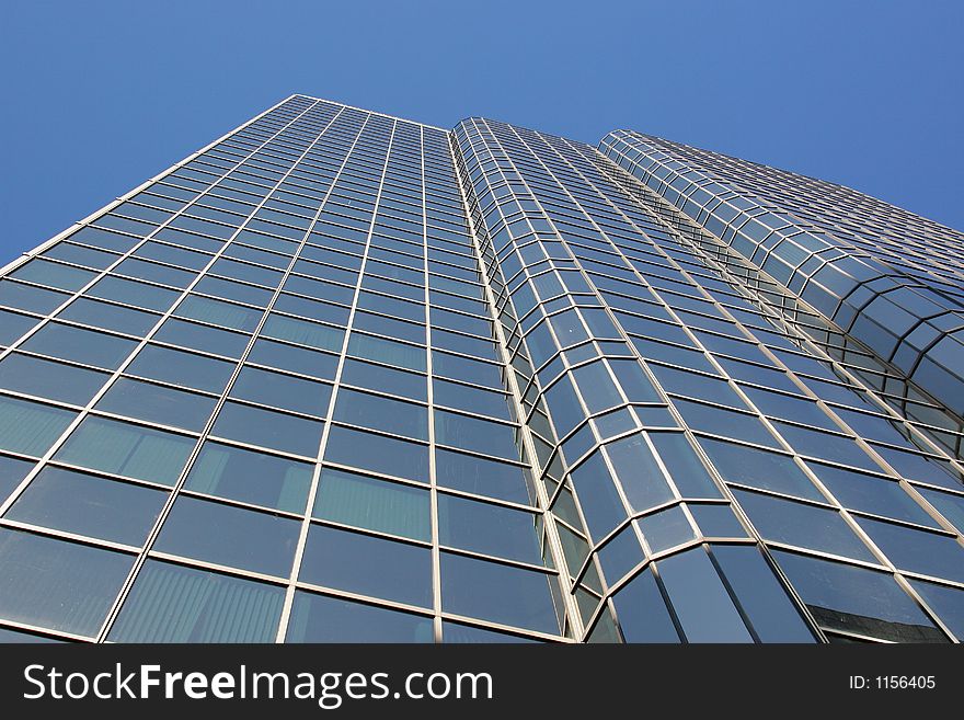 Corporate downtown office building looking up towards a blue sky. Perfect for corporate brochure. Corporate downtown office building looking up towards a blue sky. Perfect for corporate brochure.