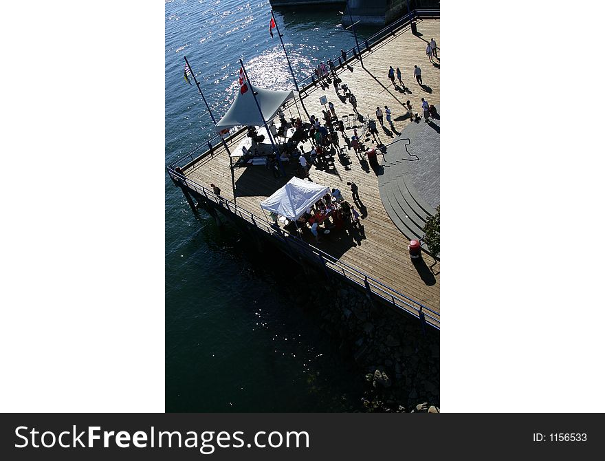 Wooden deck with band and celebration taking place on the water. Wooden deck with band and celebration taking place on the water.