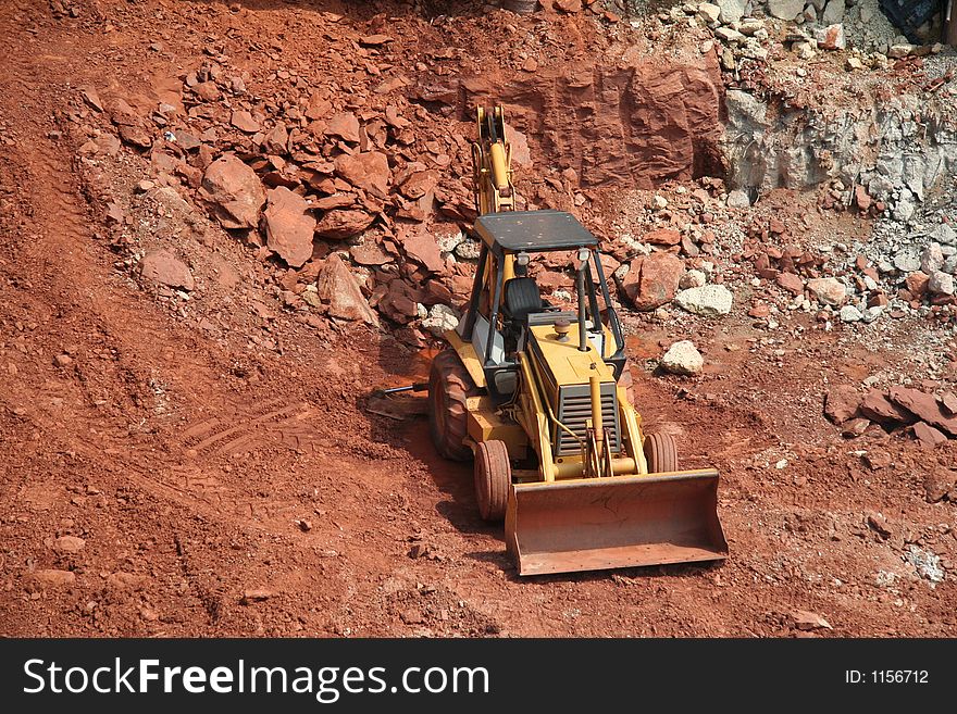 Bulldozer at construction site working in gravel pit