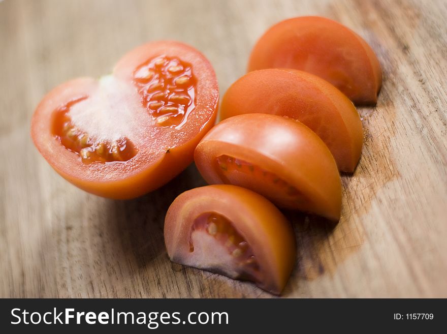 Cut tomato on a wooden surface