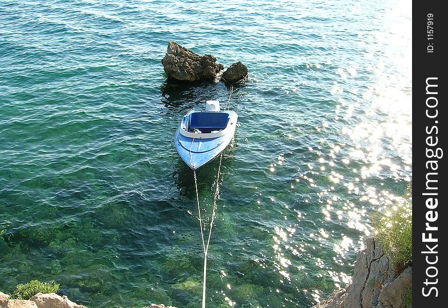 Boat by the stone on the sea