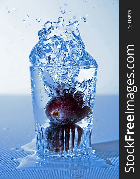 Fruit falling in a glas of water. Fruit falling in a glas of water