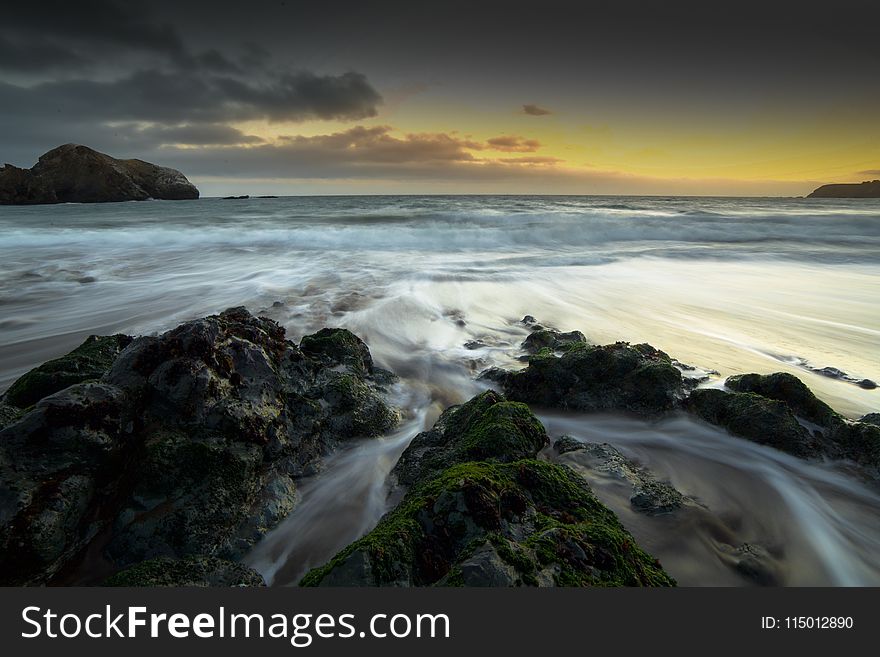 Rocks On Seashore During Golden Hour