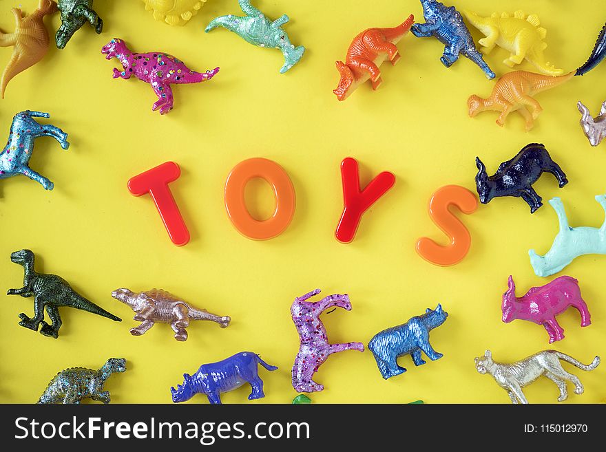 Assorted Plastic Toy on Yellow Surface