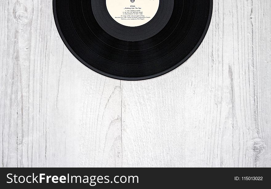 Black Vinyl Record on Wooden Surface