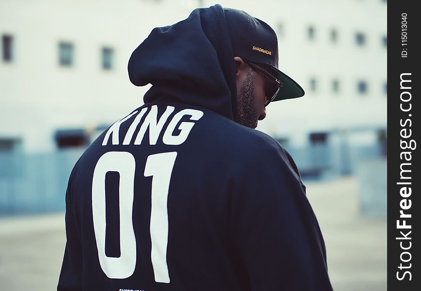 Man Wearing Black King 01-printed Hoodie and Flat Brim Cap
