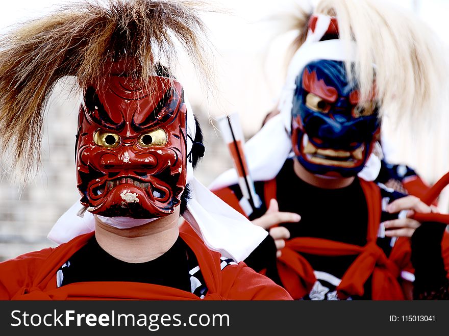 Person&#x27;s Wearing Red and Blue Kabuki Masks