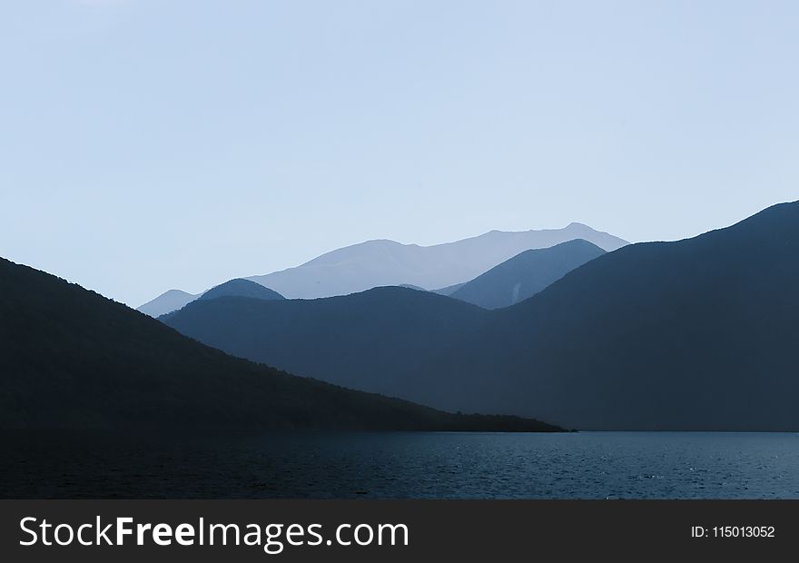 Photo of Mountains Near Body of Water