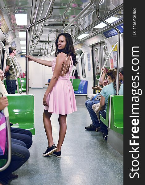 Woman Wearing Pink Sleeveless Dress Inside the Train