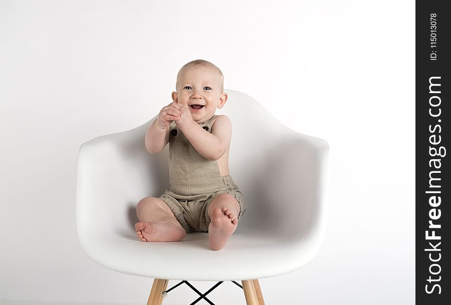Baby Sitting on White Chair