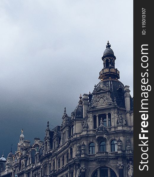 Beige Concrete Building and White Clouds