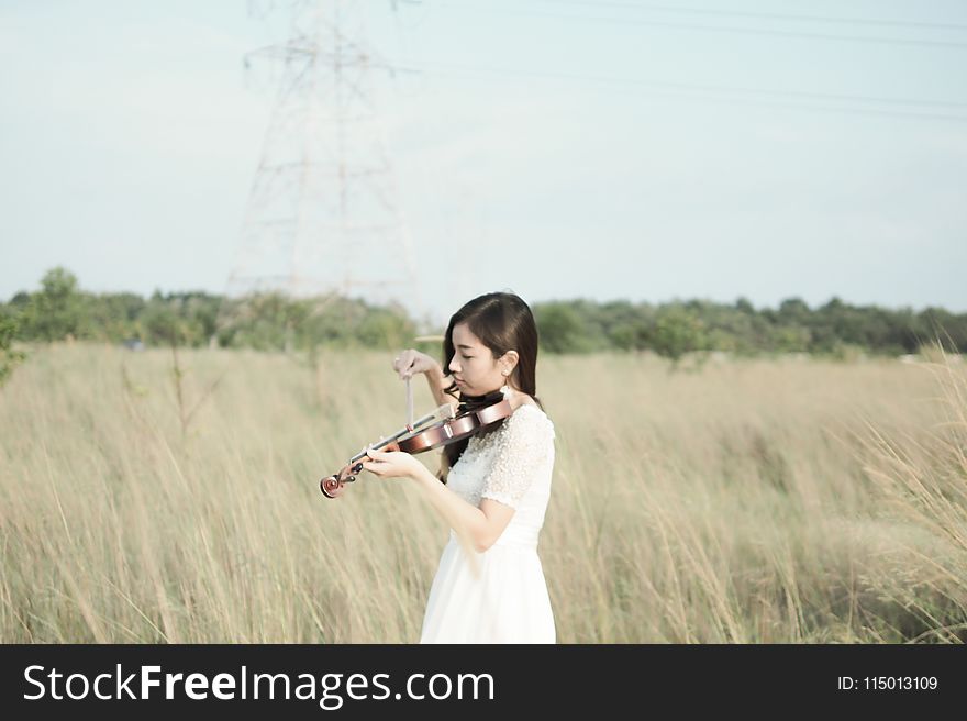 Woman Wearing White Dress Playing Violin