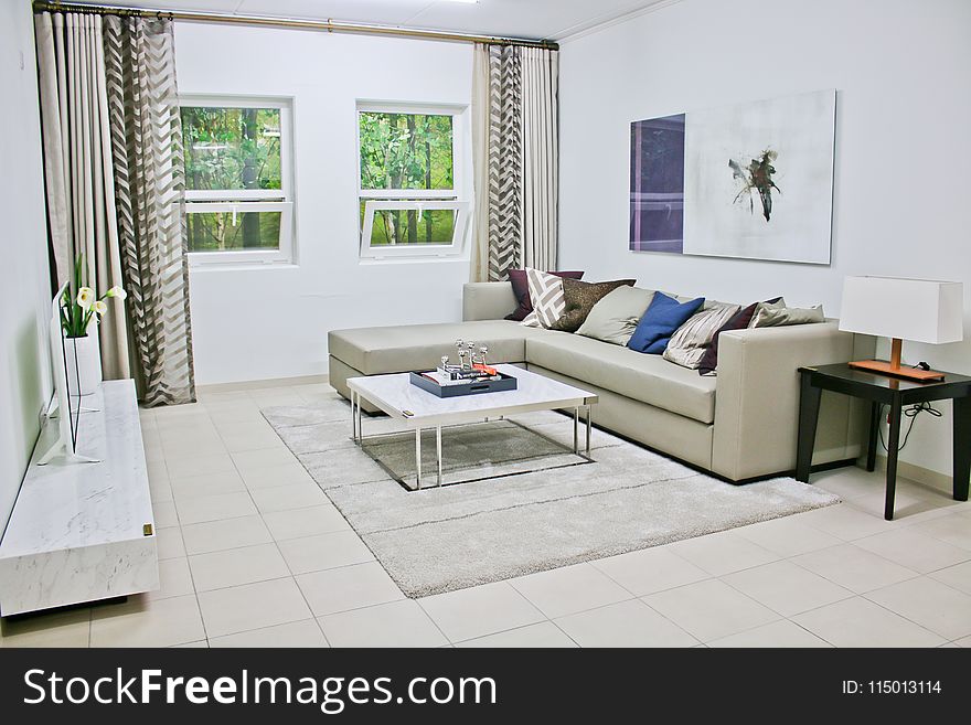 Gray Leather Sectional Sofa With White Coffee Table