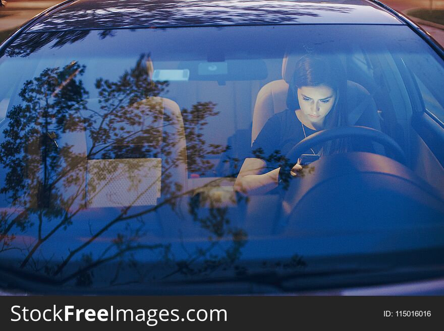 Beautiful girl model sitting in the car and use the phone. Beautiful girl model sitting in the car and use the phone