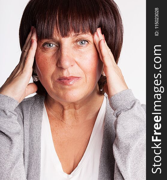 Mature woman has a headache. Sad female