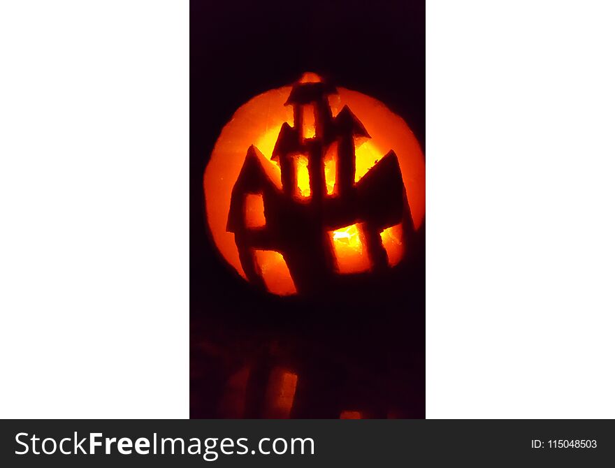 Halloween Pumpkin carvings with candle lights showing haunted house and dark