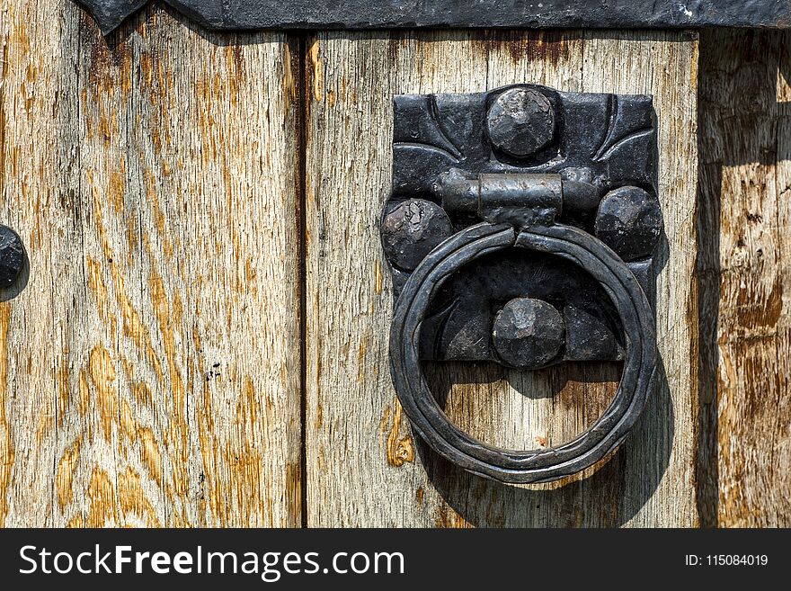 Old wooden door with aged metal door handle