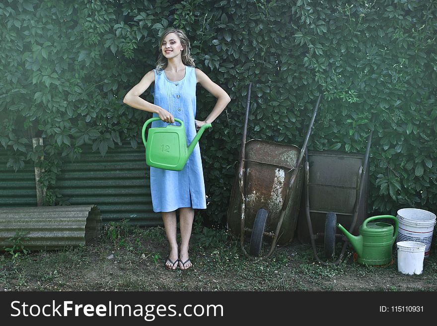 Photo of Woman Holding Watering Can