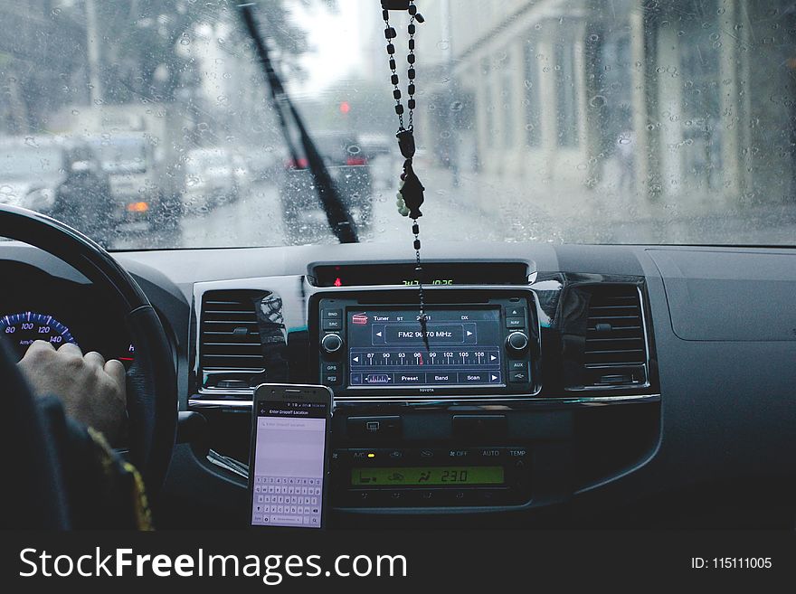 Photo of Person Driving Car While Raining