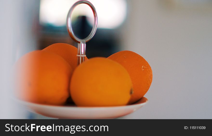Selective Focus Photography of Orange Fruits on White Plate