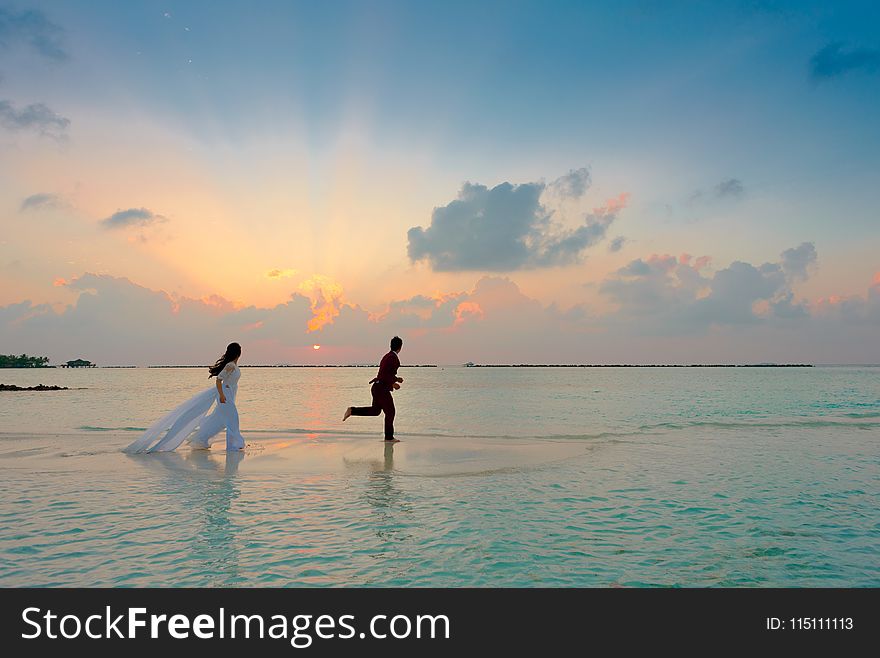 Man and Woman Standing at Seashore
