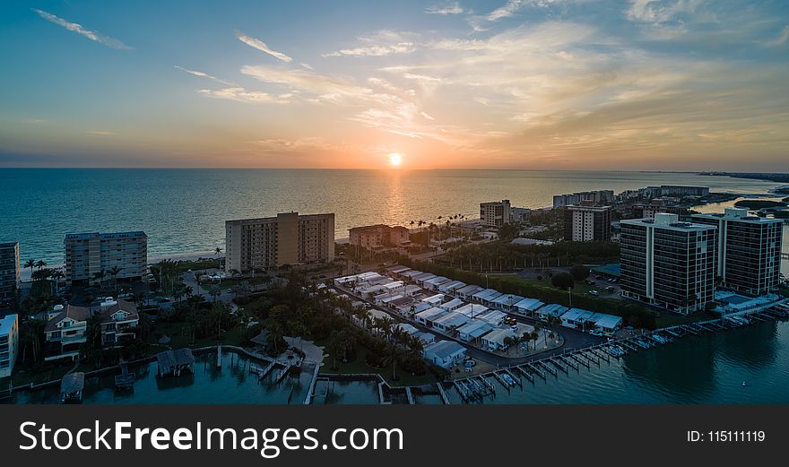 Skycraper Near Ocean Under Sunset