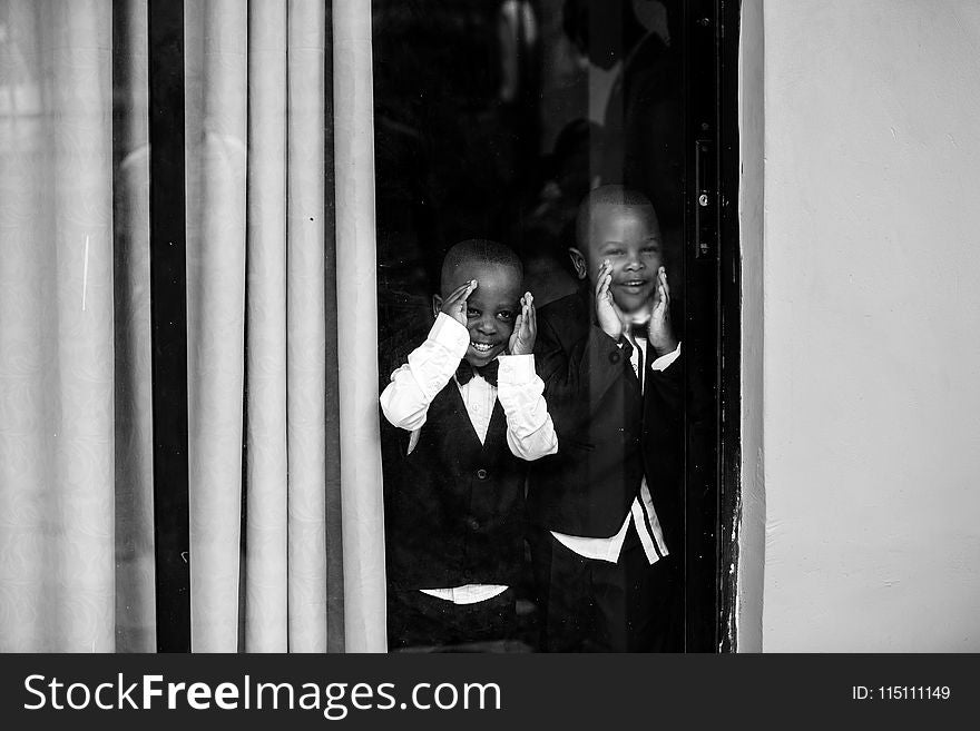 Two Boys In Front Of Glass Window