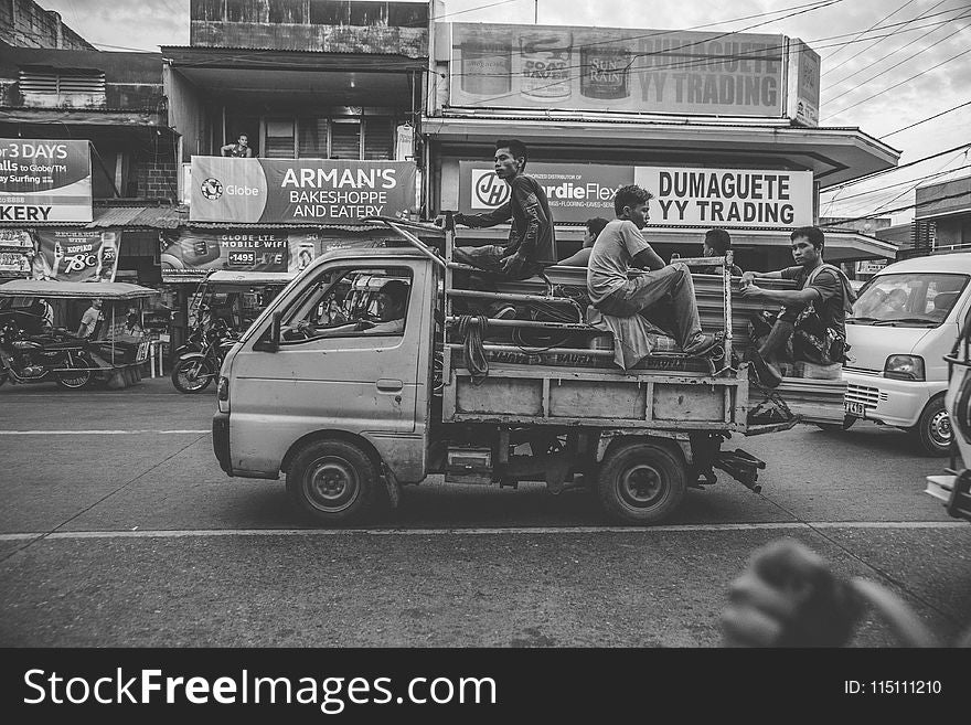 Grayscale Photo Of Men Riding On Kei Truck