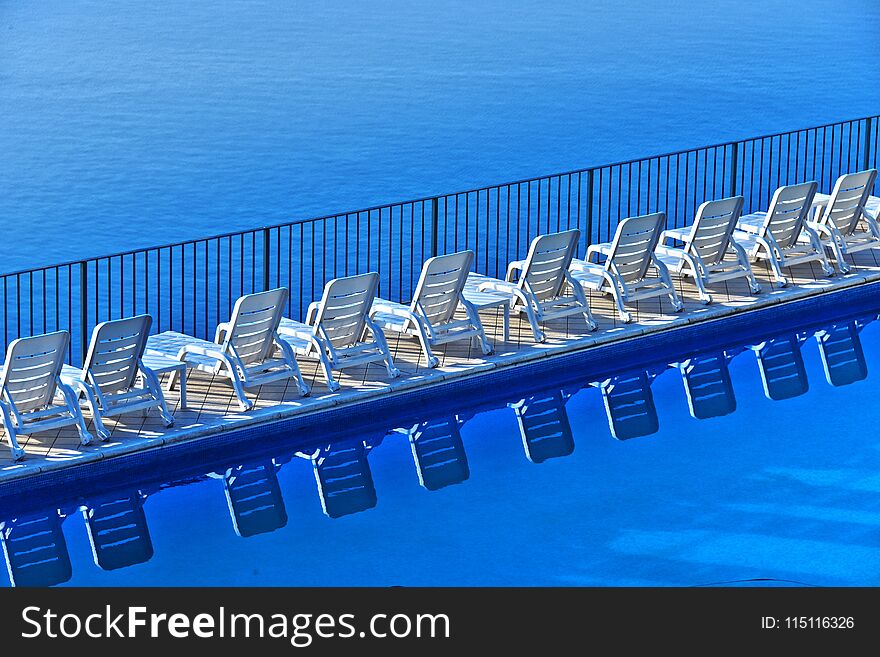 Row Of Free Sunbeds At The Swimming Pool In A Touristic Resort