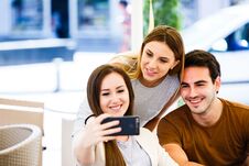 Young Friends Taking Selfie While Sitting At Cafe Stock Images