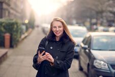 Attractive Stylish Woman With Long Blond Hair Using Her Mobile Stock Photos