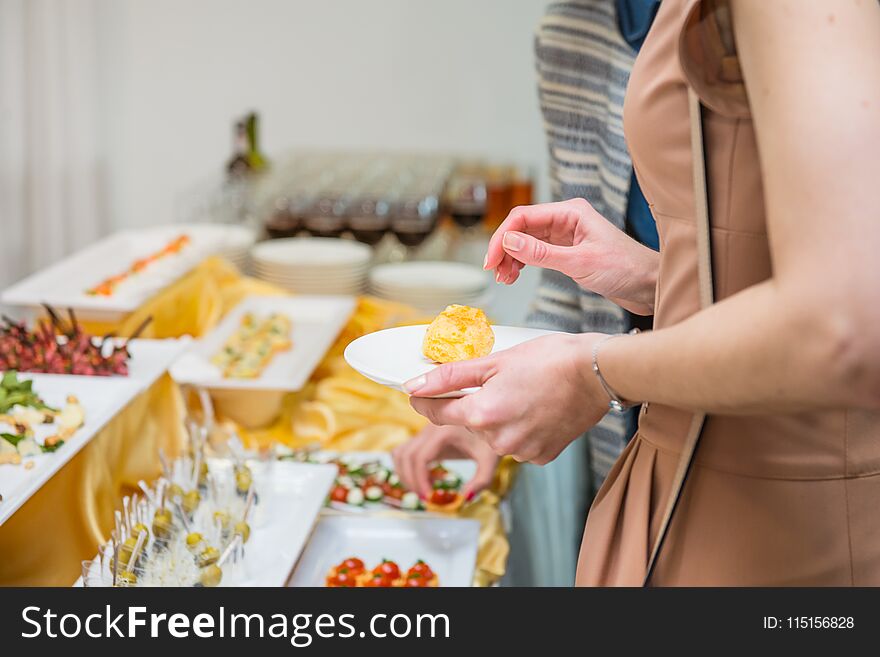 Catering buffet table with food and snacks for guests of the event. Group of people in all you can eat. Dining Food Celebration Party Concept. Service at business meeting, weddings. Selective focus