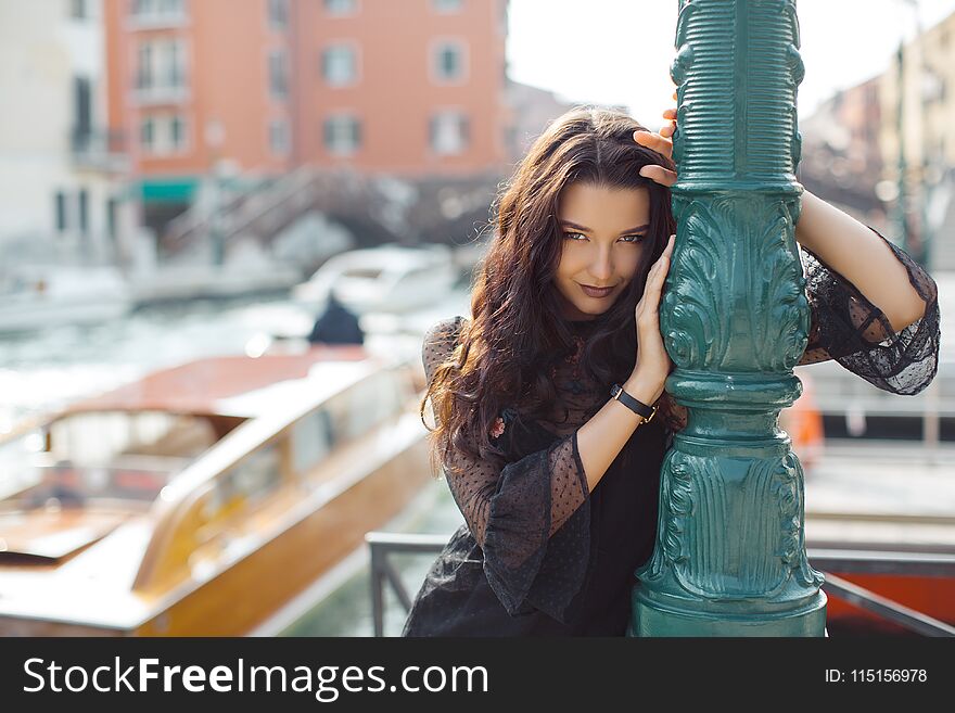 Travel tourist woman on pier against beautiful view on venetian chanal in Venice, Italy.