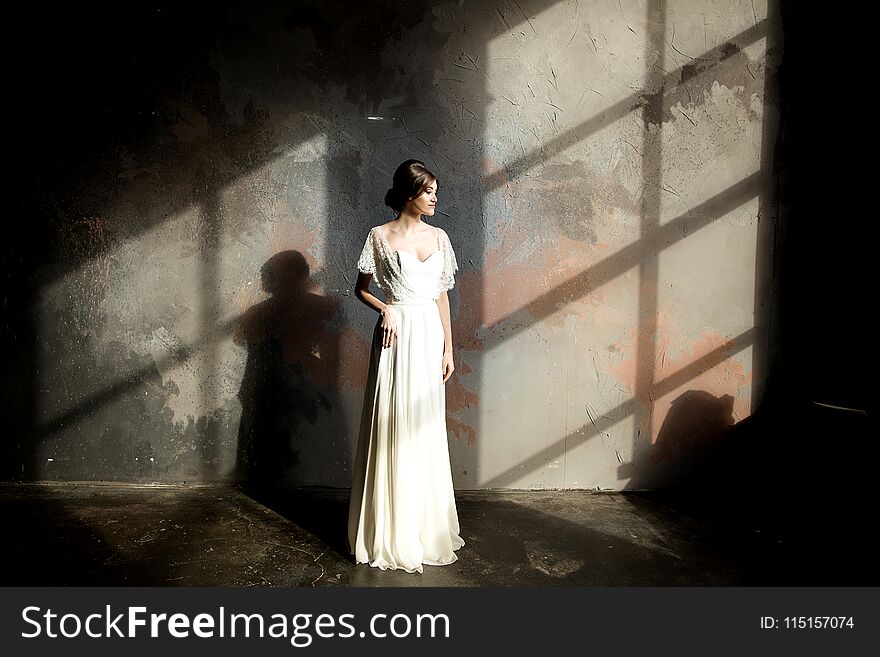 Portrait of beauty bride in white dress. bride`s fees.