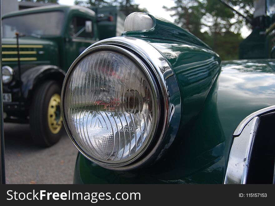 Retro Mint condition antique Chevy Chevrolet pick up truck from 1946 with oil barrels on the back in the swedish woods driving on dirt roads. Beautiful racing green colour